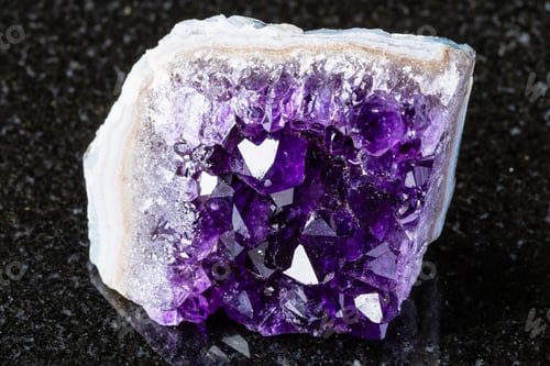 Preview: rough geode of amethyst mineral crystals on black