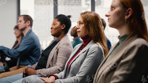 Preview: Business Conference Audience Listening to Presentation Indoors