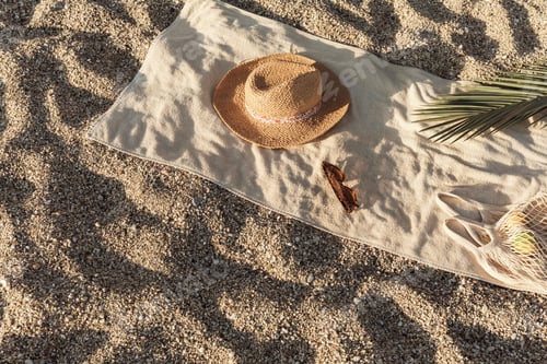 Preview: Straw hat, sunglasses, towel, bag on beach sand background. Aesthetic lifestyle, vacation concept