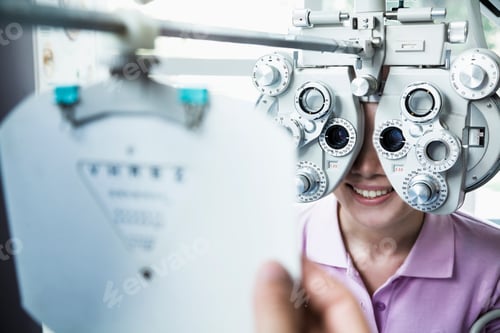 Preview: Close-up of optometrist doing an eye exam on young woman