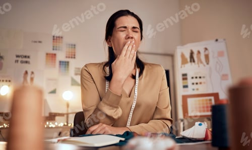Preview: Tired fashion designer, woman and yawn while working at night in creative office, textile studio or