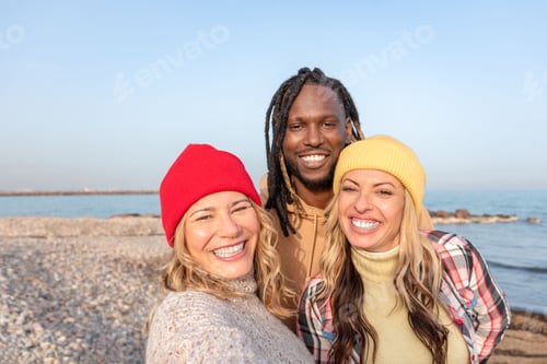 Preview: Happy multiracial diverse friends smiling and taking selfie on the beach