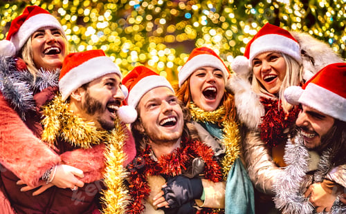 Preview: Young friends walking with santa hats at winter travel location on piggy back move