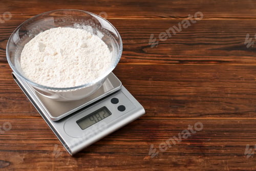 Preview: Electronic kitchen scale with bowl of flour on wooden table. Space for text