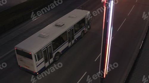 Preview: Top down view of the street lantern in the late evening with driving bus. Stock footage. Almost