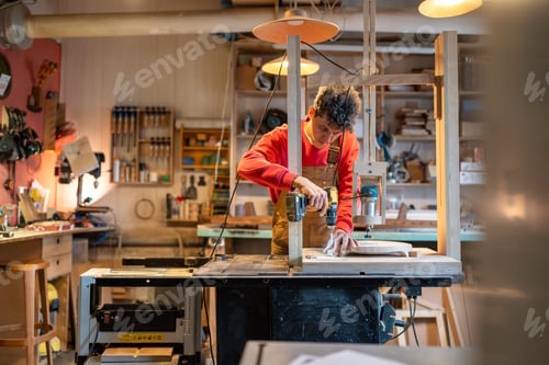 Preview: Carpenter installs wooden block to be processed with joinery machine screwing board for stability