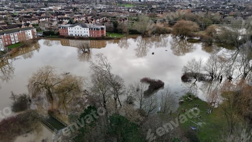 Preview: flood waters in a city area near houses and a park