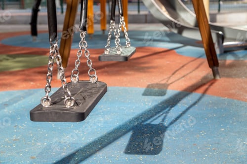 Preview: Empty swings on modern playground in summer