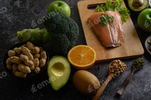 Preview: legumes, fruit, and Salmon fish pieces on a wooden chopping board.