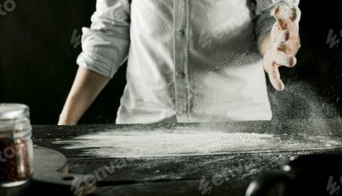 Preview: Cook kneads dough with flour on kitchen table stop motion