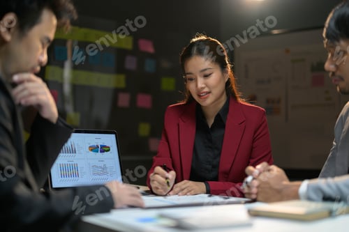 Preview: Business Team Meeting in Modern Office with Charts and Graphs on Laptop Screen