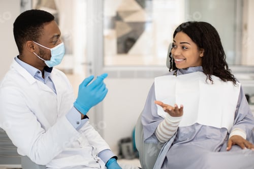 Preview: Professional Stomatologist Doctor Discussing Treatment Process With Female Patient In Clinic
