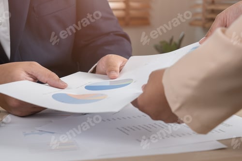 Preview: Business persons discuss on paper document chart and graph report teamwork and leadership concept