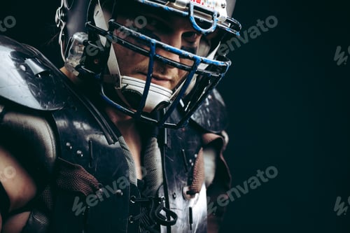 Preview: Intense Man in American Football Gear Against Black