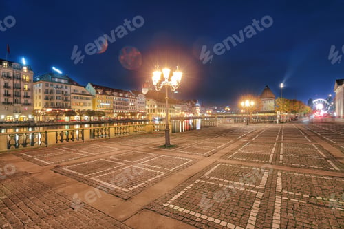 Preview: Gorgeous historic city center of Lucerne with famous buildings and promenade during night.