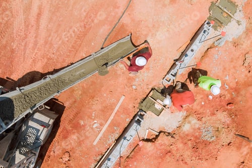 Preview: Worker preparing process of concrete pouring cement into of building trenches using a mixer truck