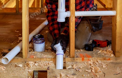 Preview: Plumber Connecting PVC Pipes in a New Building