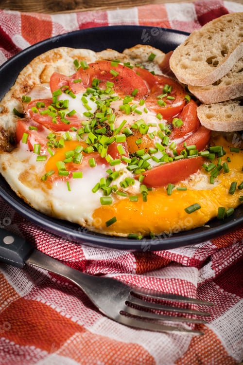 Preview: Homemade breakfast fried egg with tomato.