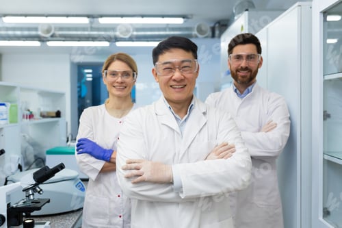 Preview: Portrait of a group of interracial scientists, a man and a woman standing in a laboratory in white