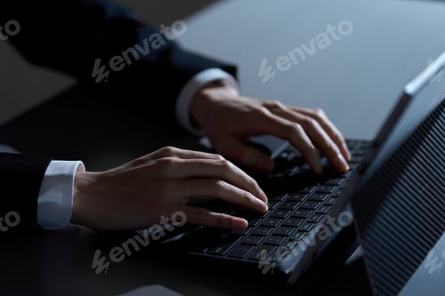 Preview: Asian businessman working on computer at night