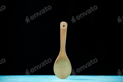 Preview: front view round wooden spoon placed upright on black background with free space