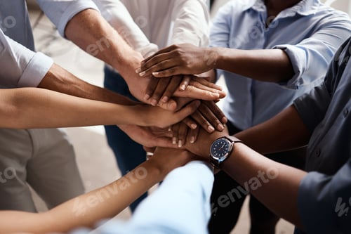 Preview: Shot of a group of unrecognizable businesspeople stacking their hands at work