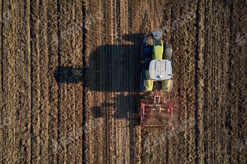 Preview: Tractor working on agricultural field, plowed farmland