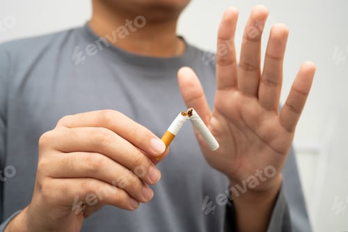 Preview: Quit smoking, Asian man breaking destroy cigarette in hand.