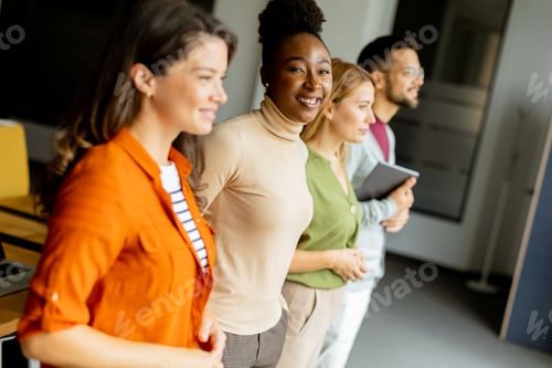 Preview: Young multiethnic startup team standing in the modern office