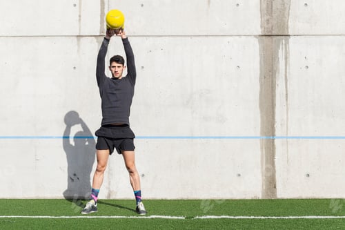 Preview: Man training with kettlebell on lawn