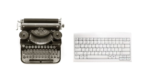 Old Typewriter and Modern Keyboard on White
