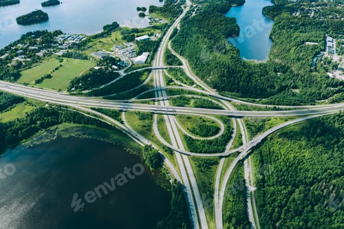 Preview: Aerial view of highway and overpass road with green woods and blue lakes in Finland.