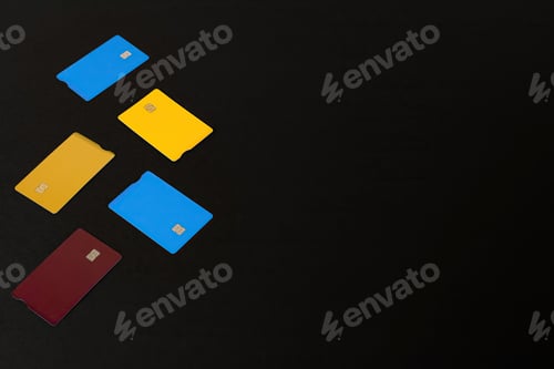 Preview: High angle shot of colorful credit card holders isolated on a dark background