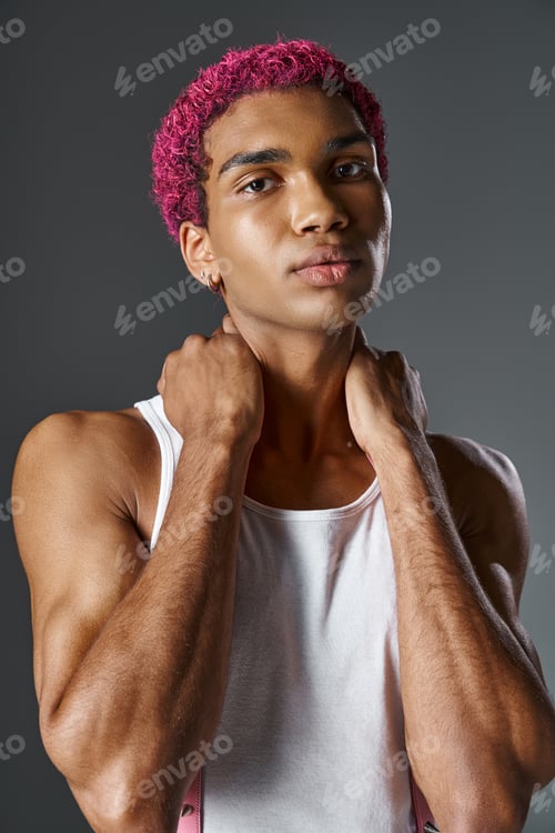 Preview: portrait of young african american man with pink hair with hands behind his neck, fashion and style