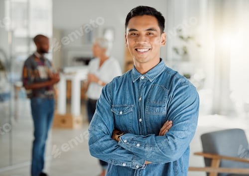 Preview: Portrait of a happy asian businessman standing with his arms crossed at work. One confident chinese