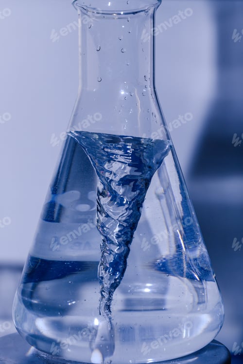 Preview: Vertical closeup shot of a laboratory glass flask filled with a liquid