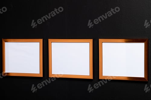 Preview: Brown empty frames with copy space on black wall