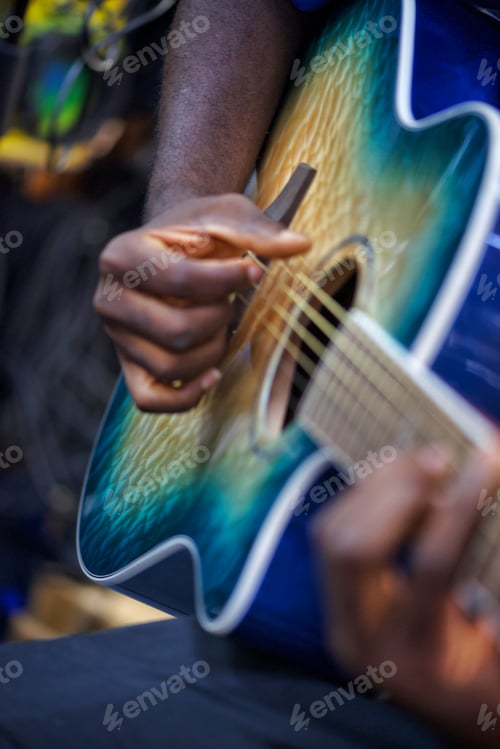 Preview: An unidentifiable black diverse young male musician guitarist plays music professionally on guitar