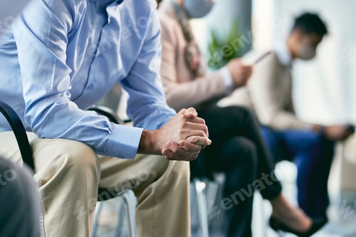 Preview: Unrecognizable businessman with hands clasped waiting for job interview.