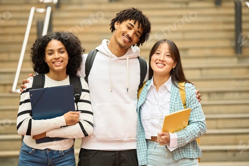 Preview: Three young students are smiling and looking to camera