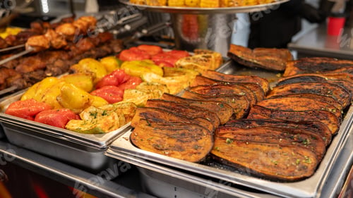 Preview: Assorted grilled vegetables and meats displayed on trays at a market stall National Brisket Day