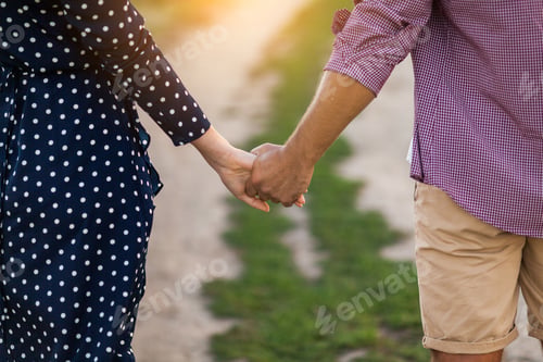 Preview: Young couple in love walking in the autumn park holding hands