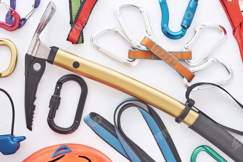 Preview: Top view. Climbing equipment for the safeness lying on the white table. Conception of extreme sports