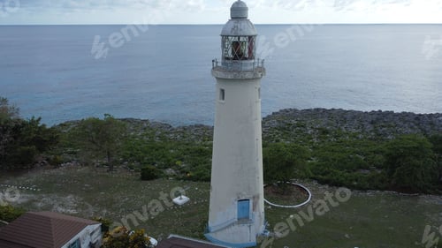 Preview: Old lighthouse against a bright sky with the backdrop of a sea