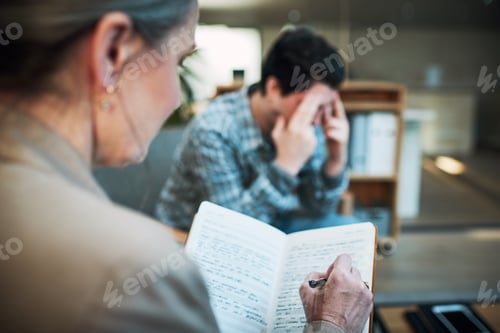 Preview: Shot of a young man having a therapeutic session with a psychologist and looking upset