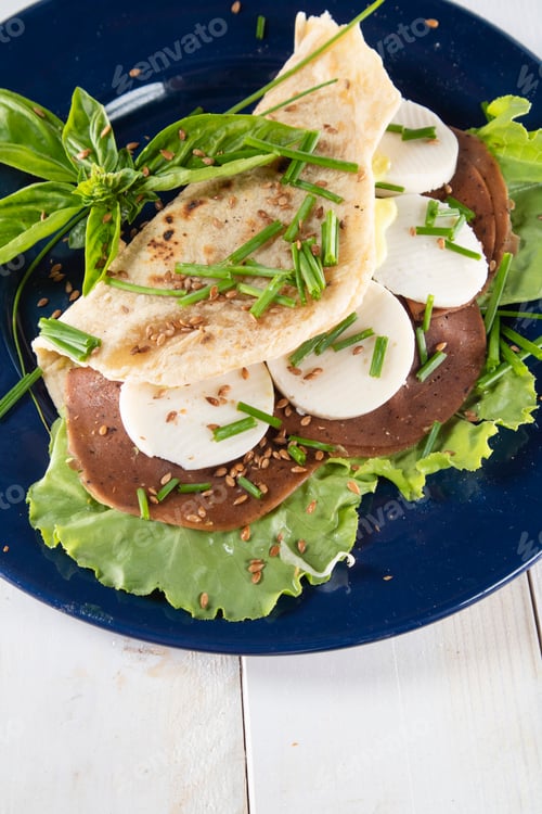 Preview: Vegan cuisine presentation of a Piadina on a blue plate