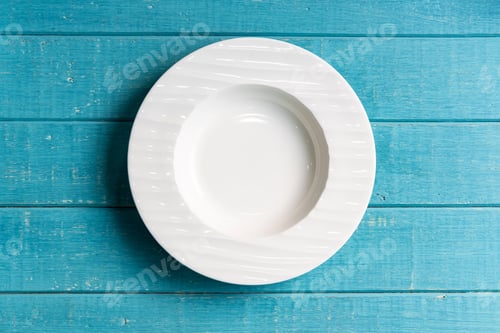 Preview: Empty white plate on wooden background, Top view