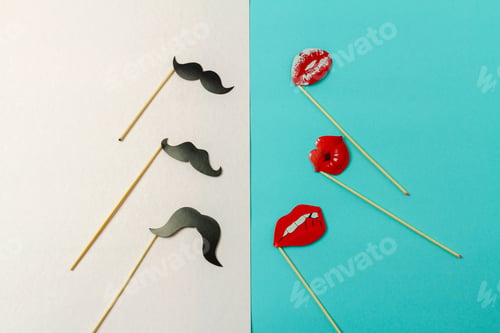 Preview: Paper moustaches and lips on wooden sticks.