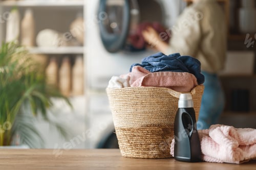 Preview: Cozy Modern Laundry Room with Basket of Fresh Towels and Deterge