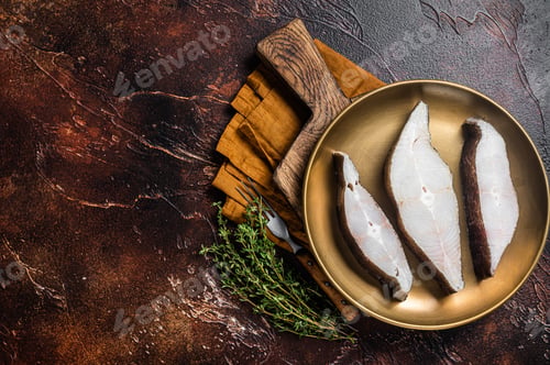 Preview: Sliced halibut fish, raw steaks on plate with thyme. Dark background. Top view. Copy space